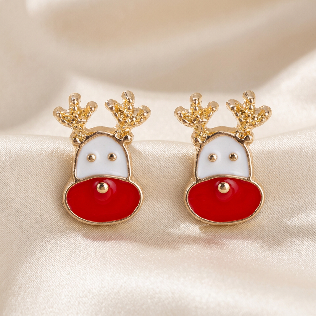 Pair of white and red reindeer face stud earrings with gold-tone antlers on ivory satin