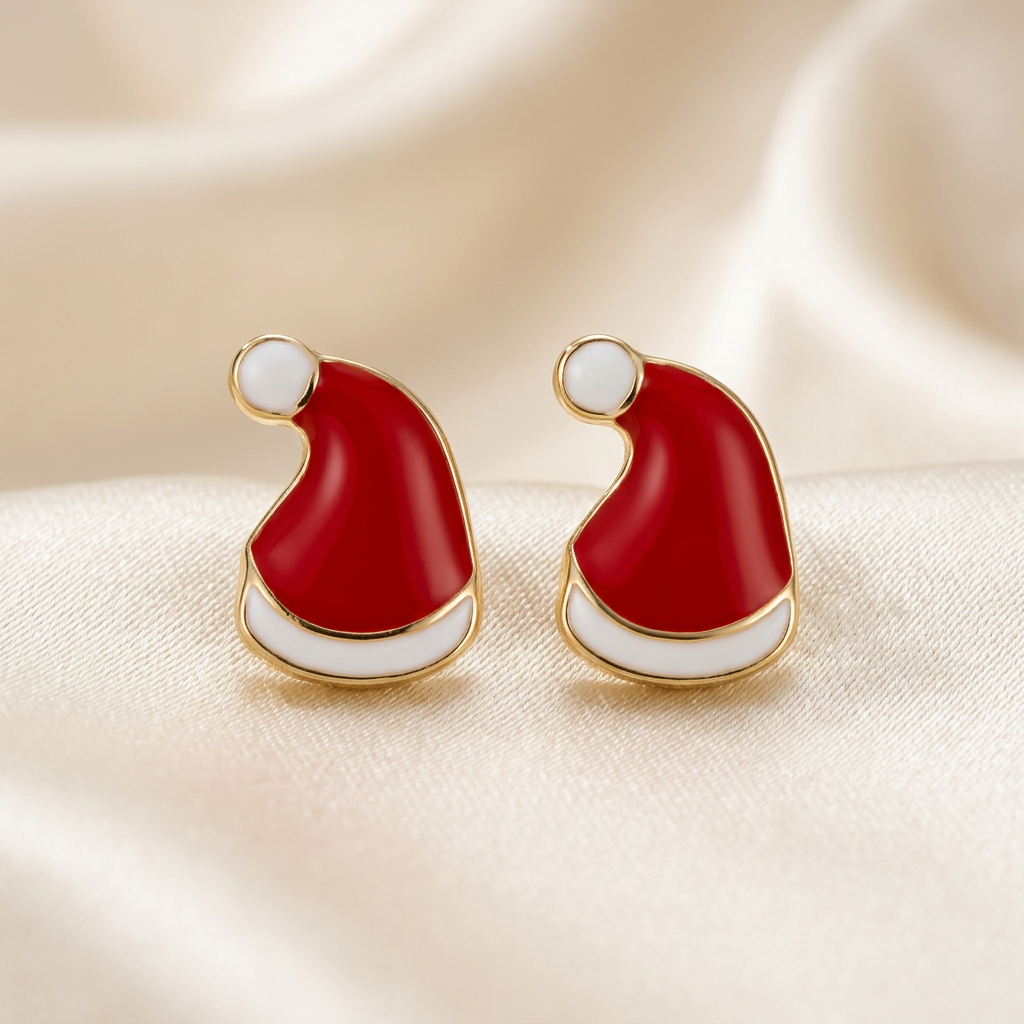 Pair of red Santa hat stud earrings with white bands and pom-poms on ivory satin