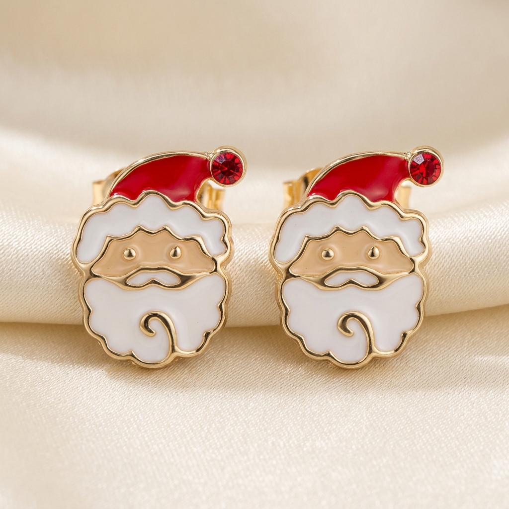 Pair of Santa face stud earrings with red hats, white beards, and red stone pom-poms on ivory satin