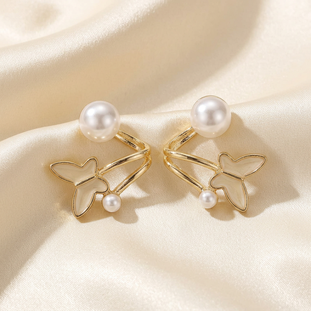 Gold-tone butterfly ear jacket earrings with white pearl-look accents