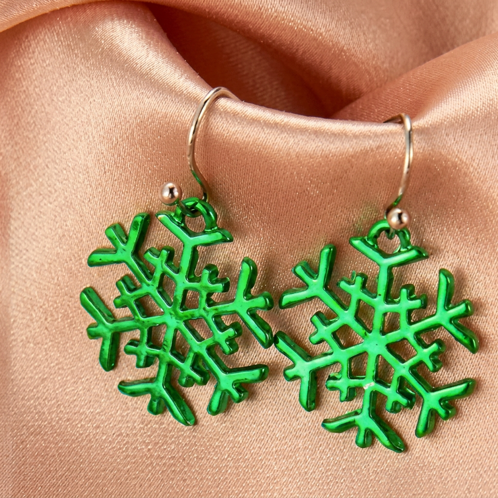 Green openwork snowflake drop earrings on champagne satin